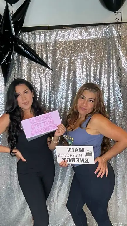 Boomerang of two friends posing with props